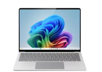 Microsoft Surface Laptop with a clean silver finish, open to display a colourful abstract wallpaper.