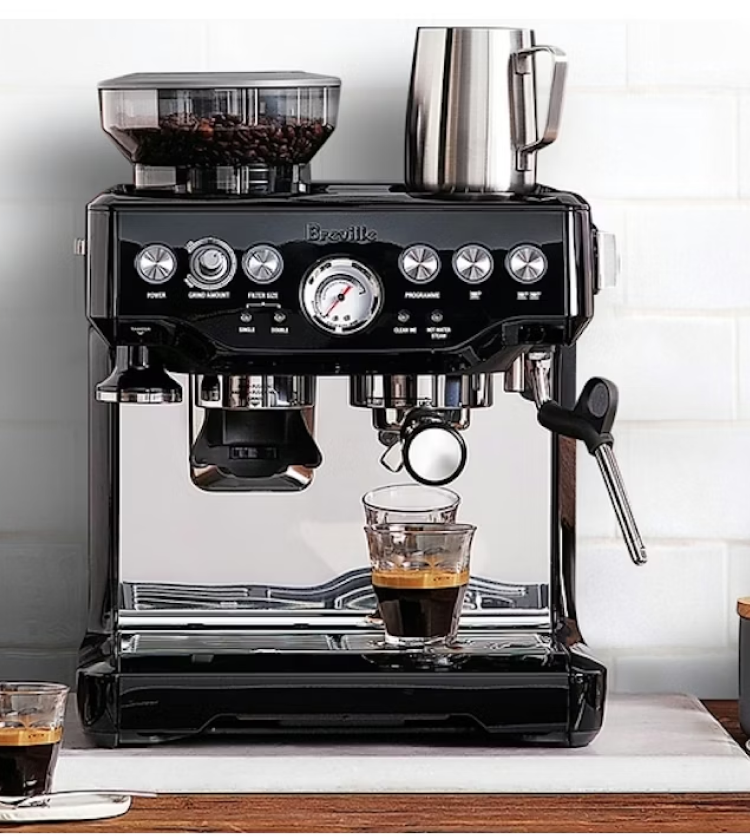 Breville barista espresso machine with grinder brewing coffee in black finish on kitchen counter