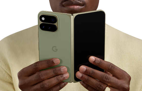 Person holding Google Pixel 11 Pro Fold open in both hands showing folded form factor 