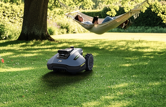 Robotic lawn mower cutting grass while a woman relaxes in a backyard hammock