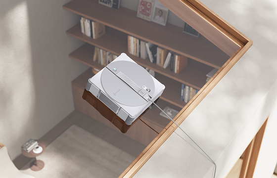 Robot window cleaner wiping a large overhead skylight in a modern living room